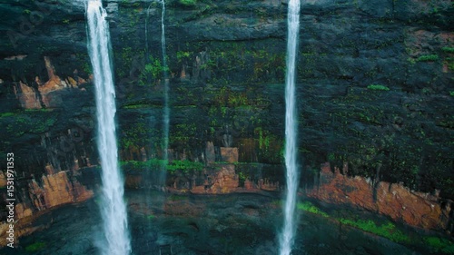 4K Aerial shot of Kataldhar waterfall flowing in Sahyadri hills during monsoon season at Lonavala, Maharashtra, India. Waterfall surrounded by lush green forest. Nature background