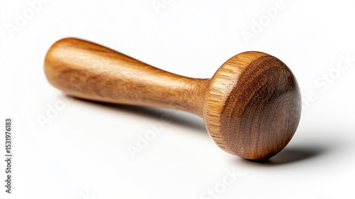 Isolated brown wooden tamper sits with soft shadows on a white photo