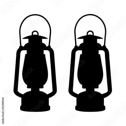Two classic hurricane kerosene lanterns in silhouette standing side by side