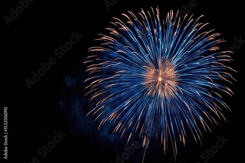 Brilliant blue and gold fireworks burst against a black night sky