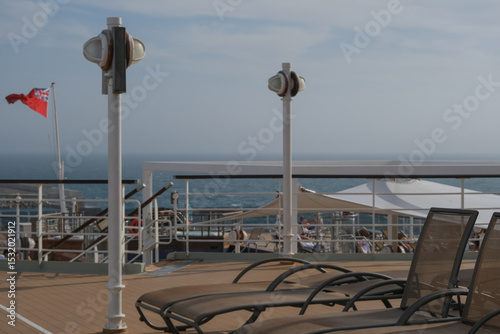 Outdoor whirlpool jacuzzi and private sun deck onboard modern luxury cruiseship cruise ship ocean liner with turquoise water, elegant rattan loungers and deck chairs for guests passengers