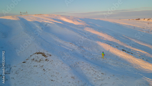 A snowboarding girl on a mountainside photo
