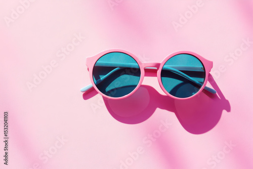 Colorful sunglasses on pink backdrop