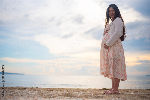 Young pregnant woman relax at the sea beach