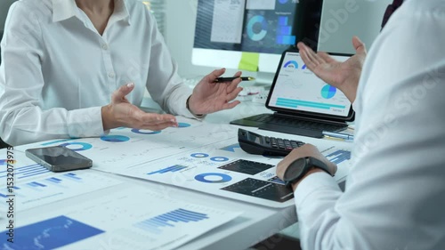Business people analyzing financial charts and data on desk