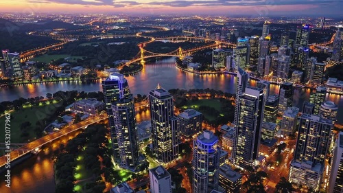 Wallpaper Mural Urban Glow: An awe-inspiring bird's-eye view showcases a bustling metropolitan skyline. Illuminated buildings reflect the glow of a vibrant cityscape, a testament to human ingenuity and urban design. Torontodigital.ca