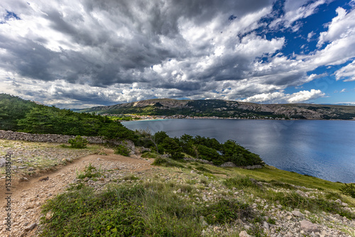 Fototapeta Naklejka Na Ścianę i Meble -  A walk along the rocky road from the beach in Baska to the top of Mount Bag,