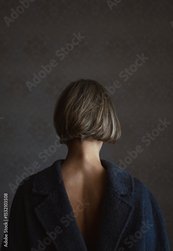 Back view on a blond woman wearing coat vice versa
