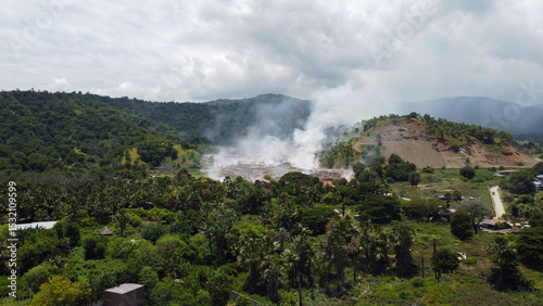 Aerial view of trash landfill with fire smoke from burning rubbish in Tibar, Dili Timor-Leste, Southeast Asia