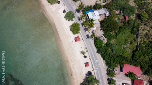 Aerial birds eye view of white sandy beach and ocean at Metiaut in capital city Dili, Timor-Leste, Southeast Asia photo