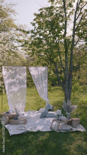 Relaxing picnic setup in a sunny garden with decorative elements and natural surroundings