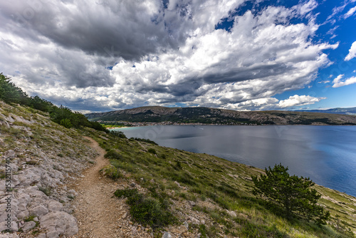 Fototapeta Naklejka Na Ścianę i Meble -  A walk along the rocky road from the beach in Baska to the top of Mount Bag,