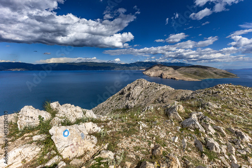 Fototapeta Naklejka Na Ścianę i Meble -  Climbing the Bag peak on the island of KRK, panorama of the city of Baska, sharp rocks, azure water,