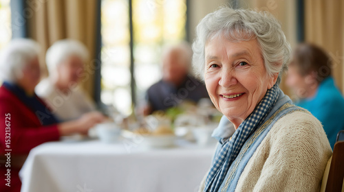Happy senior woman enjoying a meal in a friendly community dining setting.
 photo