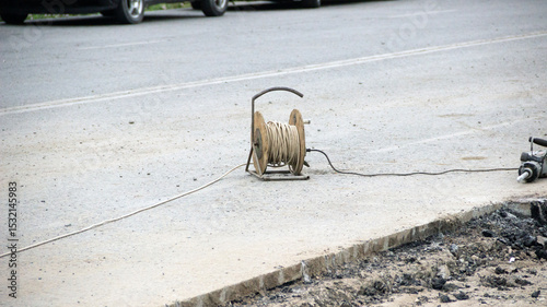 Fototapeta Naklejka Na Ścianę i Meble -  small coil with wires on the blocked road