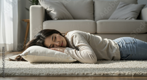 Asian Woman Lying Down on Stomach on Carpet with Pillow Indoors photo