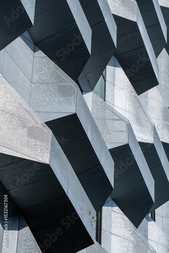 Abstract concrete pattern with geometric extrusions on a contemporary building, ideal for background in architectural design or real estate projects photo