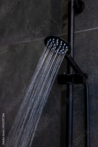 A detailed close up of a shower head with water flowing out of it