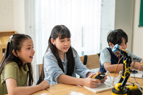 Group of students learning in a robotics class at elementary school. 