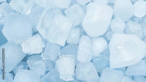 Ice cubes scattered on a blue surface for fighting the heat  