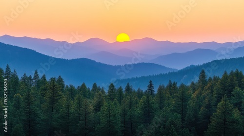 Serene landscape featuring layered mountain ranges, forested foreground, and a radiant sunset