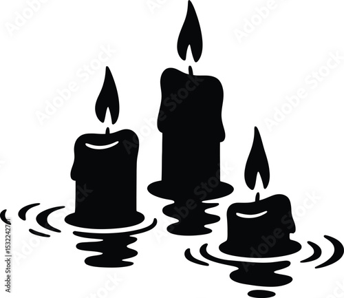 Three black candles with flickering flames reflected in water creating a serene and peaceful scene silhouette