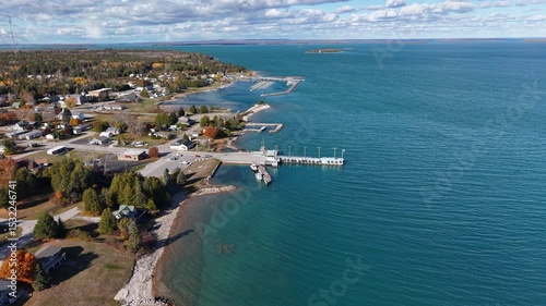 Aerial drone view of Detour Village, Michigan along the Lake Huron shoreline with docks and coastal homes photo