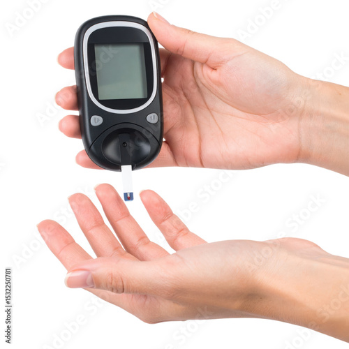 A person holds a blood glucose meter with a test strip near their fingertip for monitoring blood sugar levels.