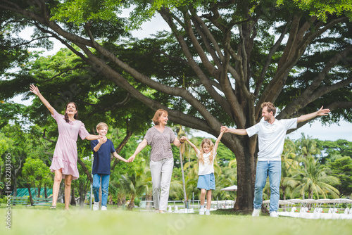 Happy family parent children having picnic outdoor activity. Enjoy happiness moment summer playing together including father mother son and daughter relaxing in the morning sunrise.