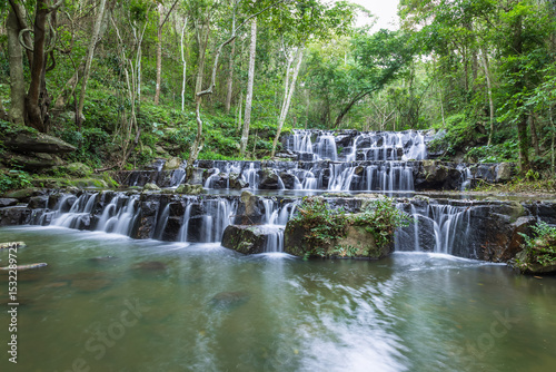 Samlan Waterfall, tier 1, layered waterfall in rainforest with natural stone steps and calm water pool,