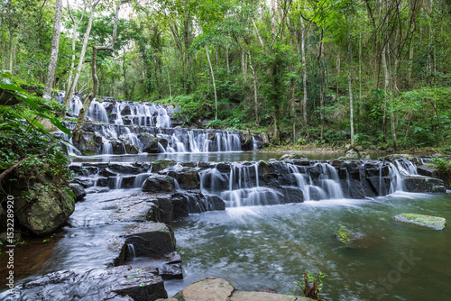 Samlan Waterfall, tier 1, multi-tiered waterfall in tropical Thailand forest with flowing water and stone steps.