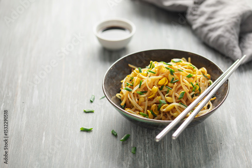 Korean soy bean sprouts salad Kongnamul Muchim  with chopsticks. Korean food side dish