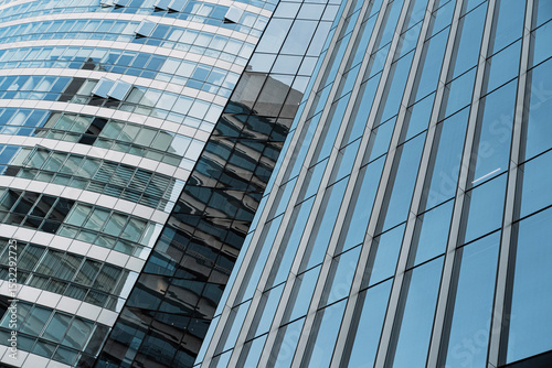Modern business district buildings with reflective facades and dynamic perspective, clean architecture for commercial or corporate presentations photo