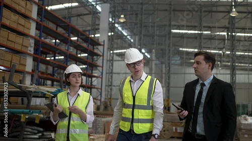 Blue collar workers are working and meeting at warehouse. Industrial and factory.