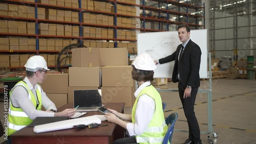 Blue collar workers are working and meeting at warehouse. Industrial and factory.
