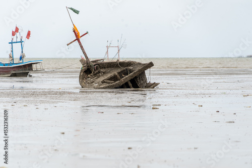Fototapeta Naklejka Na Ścianę i Meble -  A boat is on the beach with a flag on it