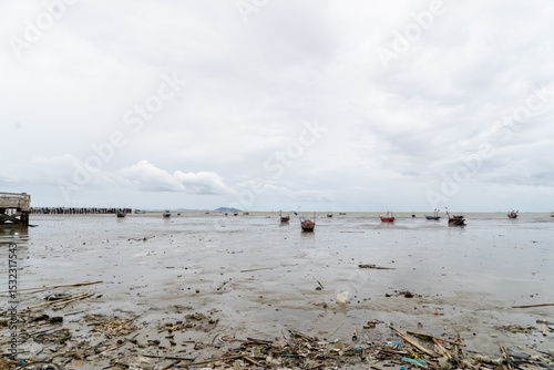 A beach with a lot of boats in the water