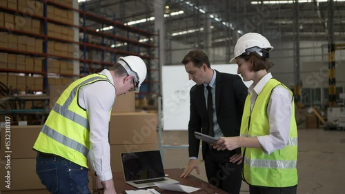Blue collar workers are working and meeting at warehouse. Industrial and factory.