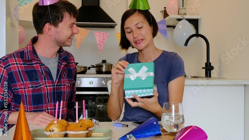 Couple talking to friends via video call, laptop screen, joyful communication, virtual celebration, connection across distance. Happy birthday at home photo