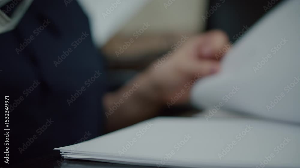 Pressing stamp on document at office desk