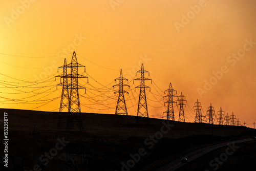 Silhouettes of high voltage electric lines during sunset, Kurdistan Region of Iraq