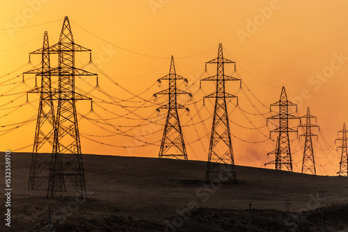 Silhouettes of high voltage electric lines during sunset, Kurdistan Region of Iraq