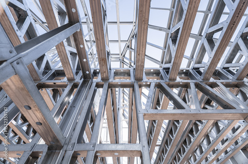 Building in construction, Metallic structure against a clear sky. New residential construction home metal framing.