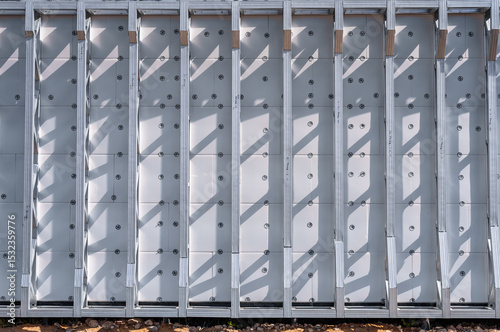 Building in construction, Metallic structure against a clear sky. New residential construction home metal framing.