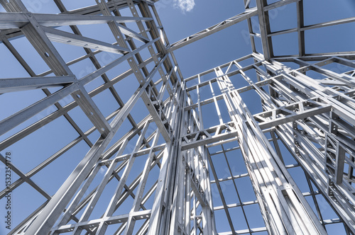 Building in construction, Metallic structure against a clear sky. New residential construction home metal framing.