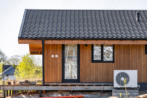 Modern frame house with panoramic windows on a pile foundation. Construction of a modern frame house on stilts. photo