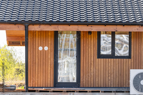 Modern frame house with panoramic windows on a pile foundation. Construction of a modern frame house on stilts. photo