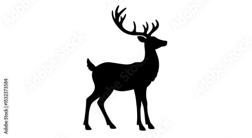 Silhouette of a standing deer with large antlers