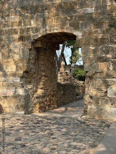 A stone archway with a stone wall