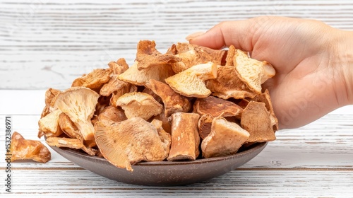 Organic Dried Mushroom Mix Held by Hand in Natural Food Photography on Wooden Table, Dried mushrooms, processed.